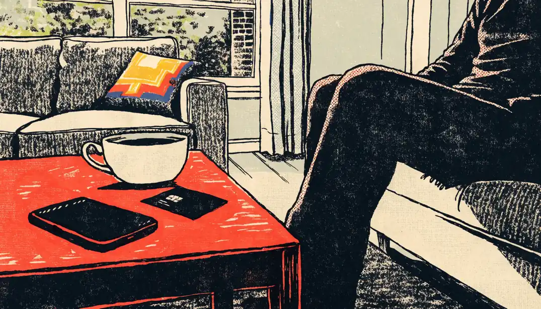 Smartphone and bank card on a coffee table in a British home, suggesting instant payout.